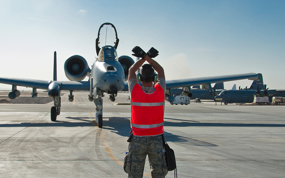 A-10 Thunderbolt II in back of ground crew member