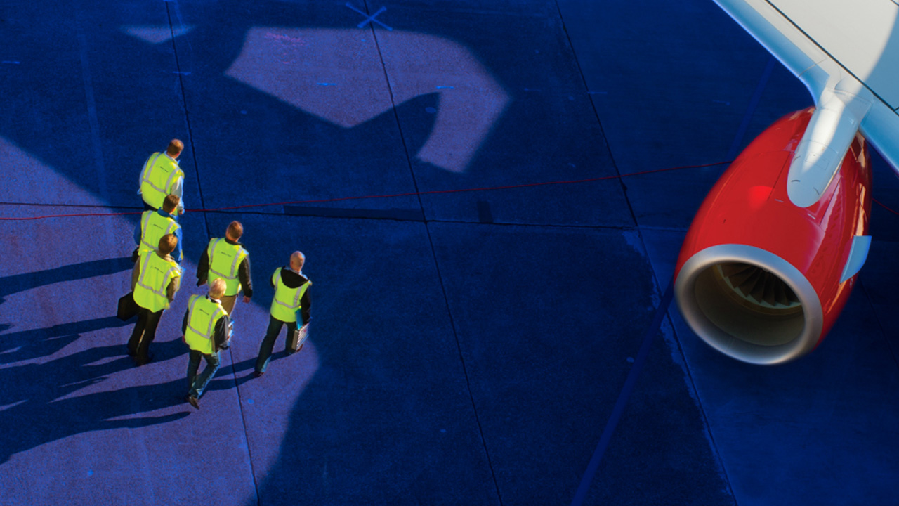 Picture of flight personnel near Boeing airplane.