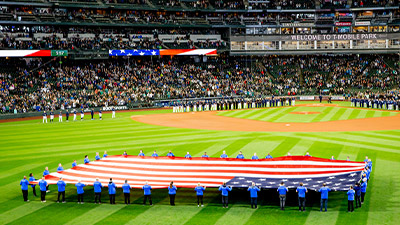 Members of the Boeing Veterans Engagement Team hold the U.S. flag during Salute to Armed Forces Night on May 7, 2022