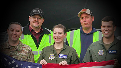 Captain Michelle McMillen poses with cousins Chad and Wade Holliston at Boeing's Military Delivery Center in Tukwila, Washington before she delivers the 64th KC-46A to the U.S. Air Force.