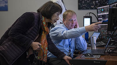 Stephanie Lu and Aaron Kraftcheck monitor the launch of Starliner for the Orbital Flight Test last December in the Blue Flight Control Room at the Mission Control Center in Houston.