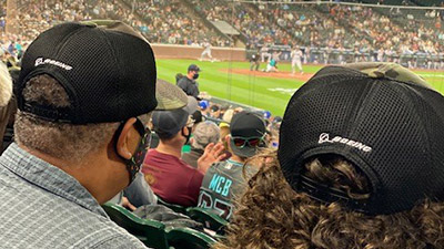 Fans wearing Mariners military caps courtesy of Boeing