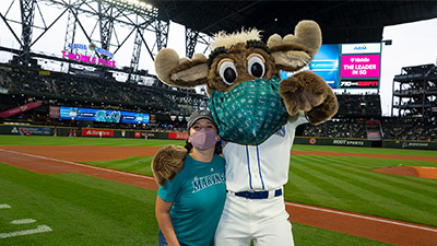 Megan Cisneros with the Mariner Moose at the final game of the season.